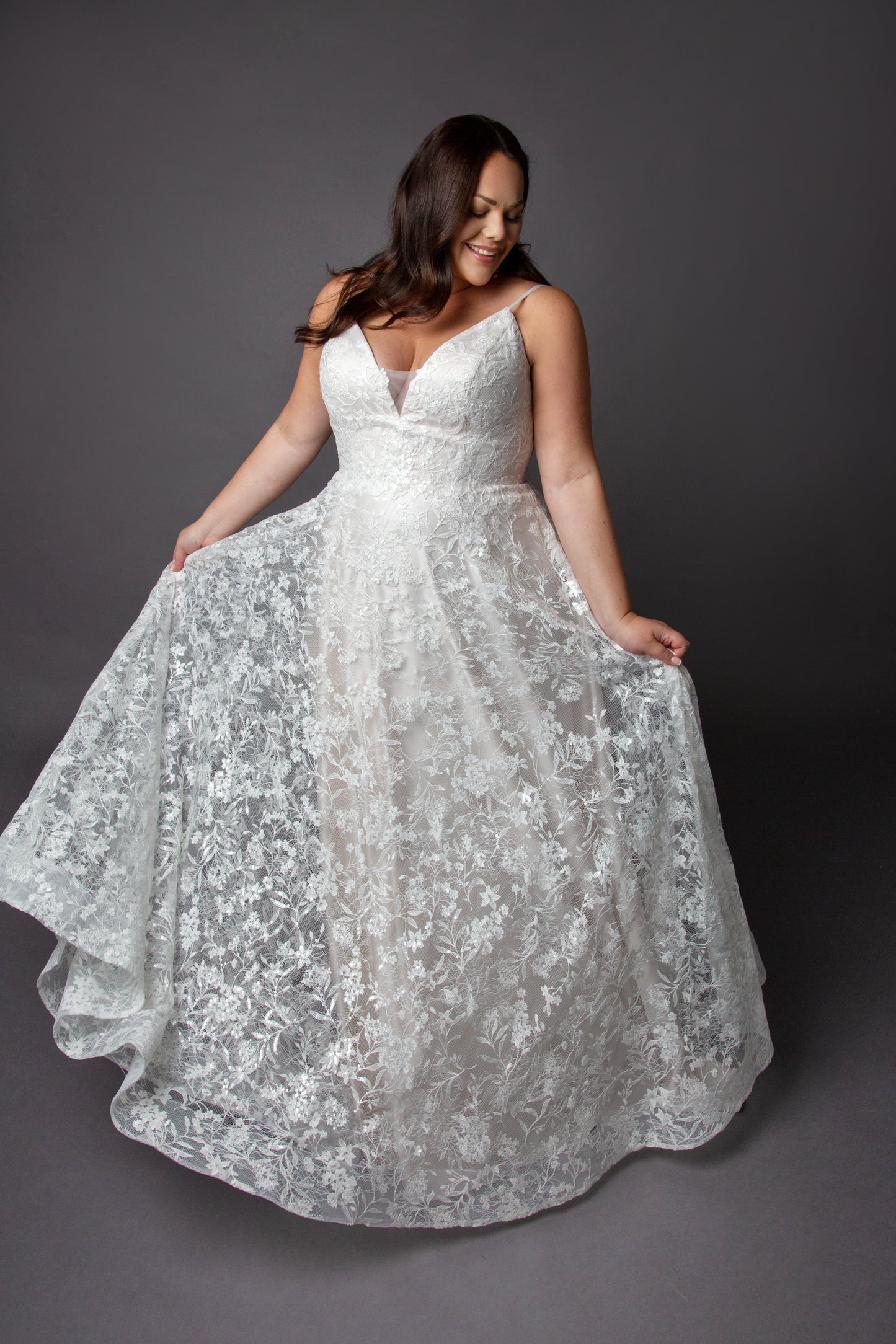 Lace wedding dress with spaghetti straps and full circular skirt