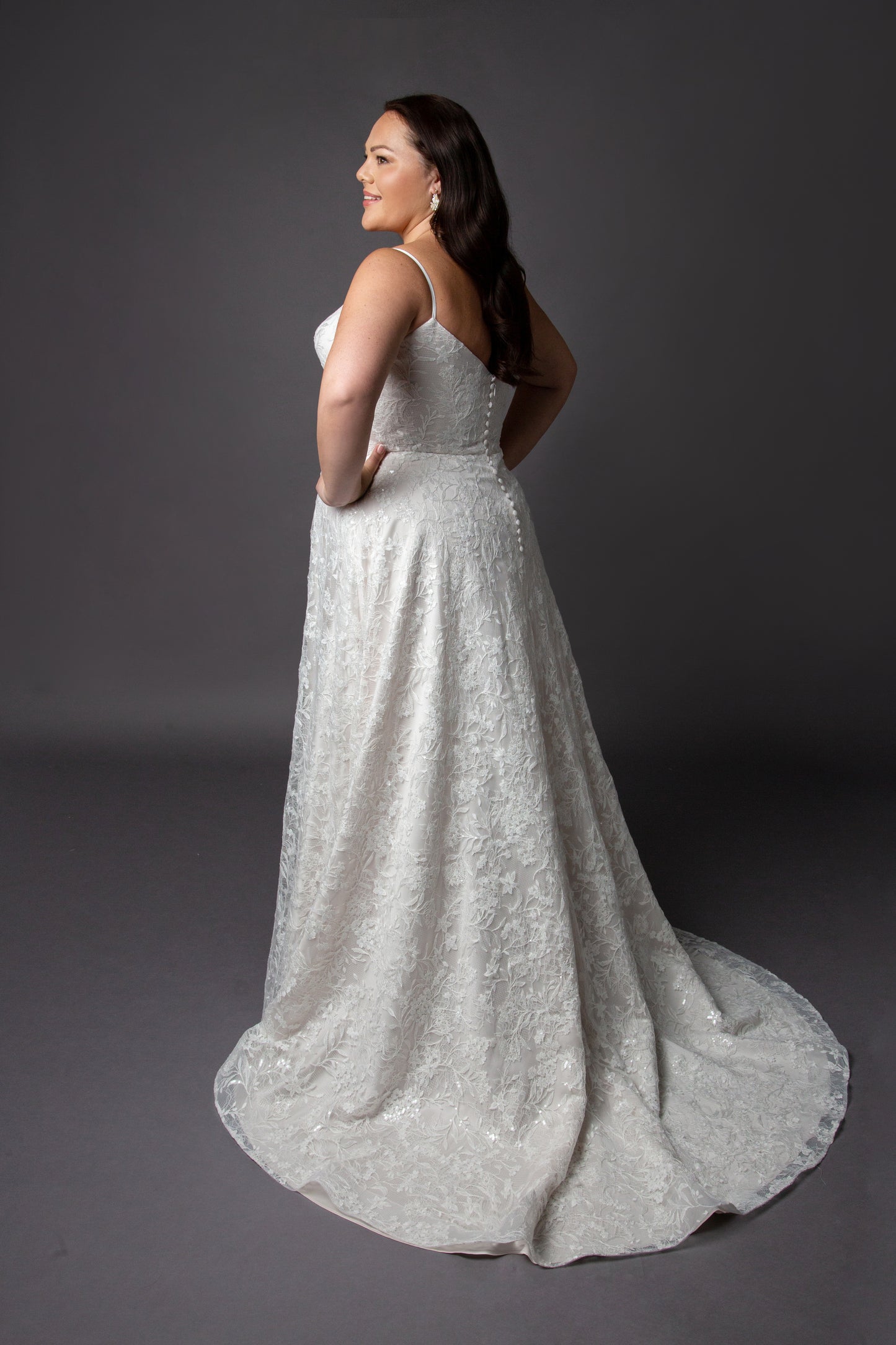 Lace wedding dress with spaghetti straps and full circular skirt