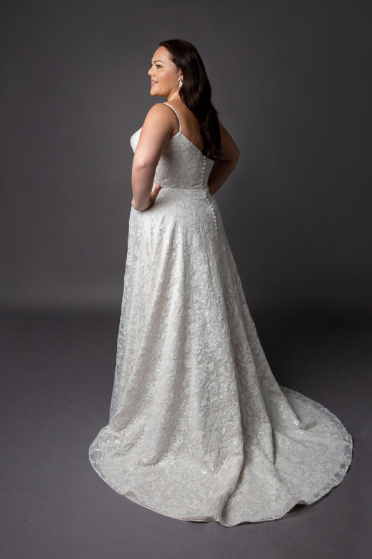 Lace wedding dress with spaghetti straps and full circular skirt