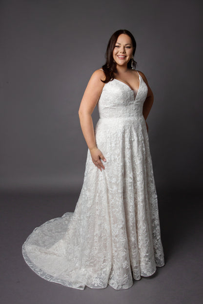 Lace wedding dress with spaghetti straps and full circular skirt