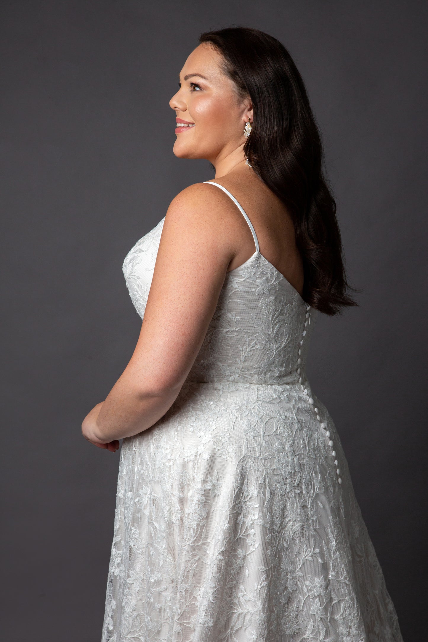 Lace wedding dress with spaghetti straps and full circular skirt